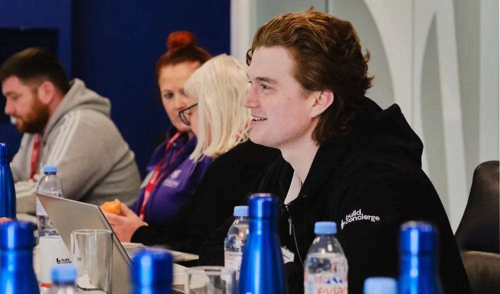 A Build Concierge employee at an event with customers